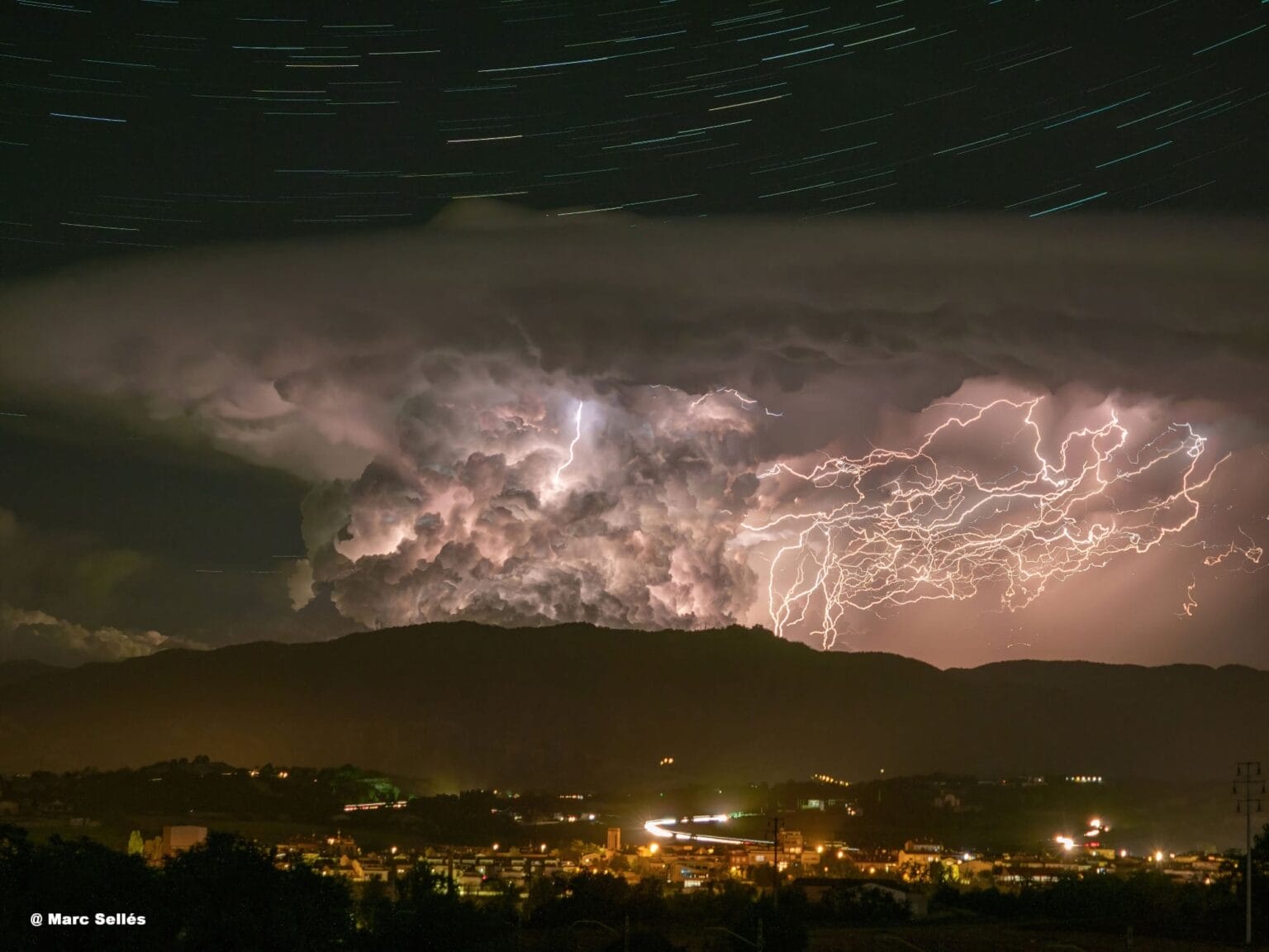 Brilliant Star Trails Sweep Above a Fierce Tangle of Lightning in a ...