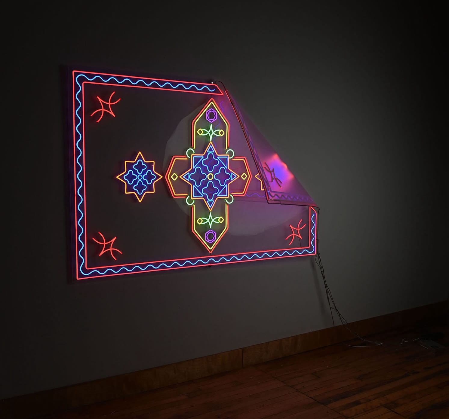 a neon sculpture by Roda Medhat depicting patterns reminiscent of traditional Kurdish rugs