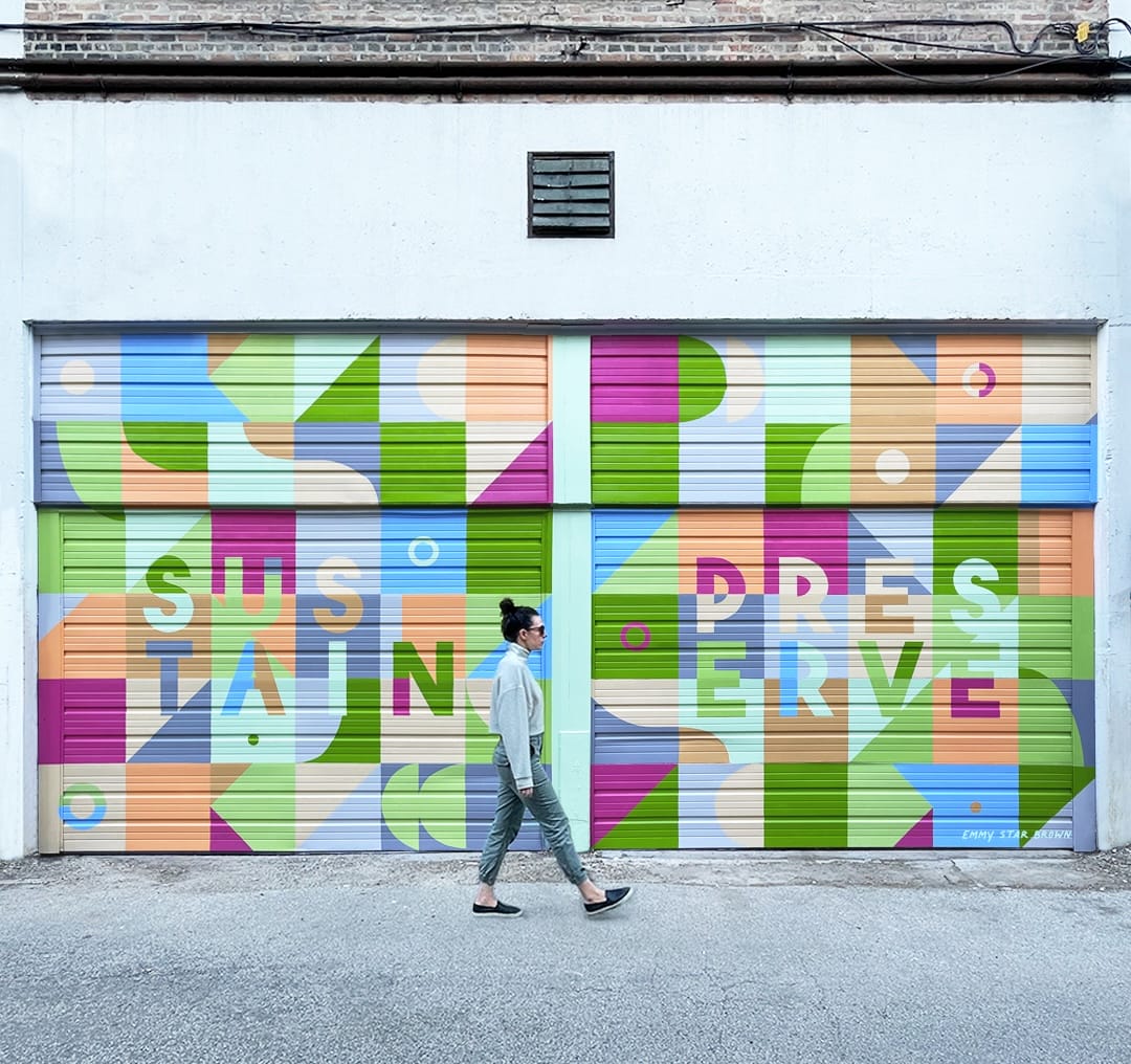 a colorful, abstract mural on a pair of garage doors by Emmy Star Brown, with the words "sustain" and "preserve"