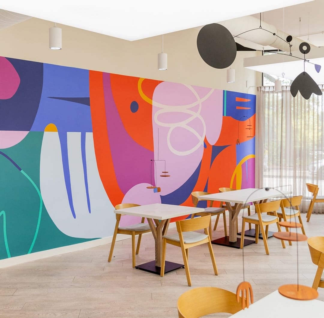 a colorful, abstract mural on an interior wall by Emmy Star Brown