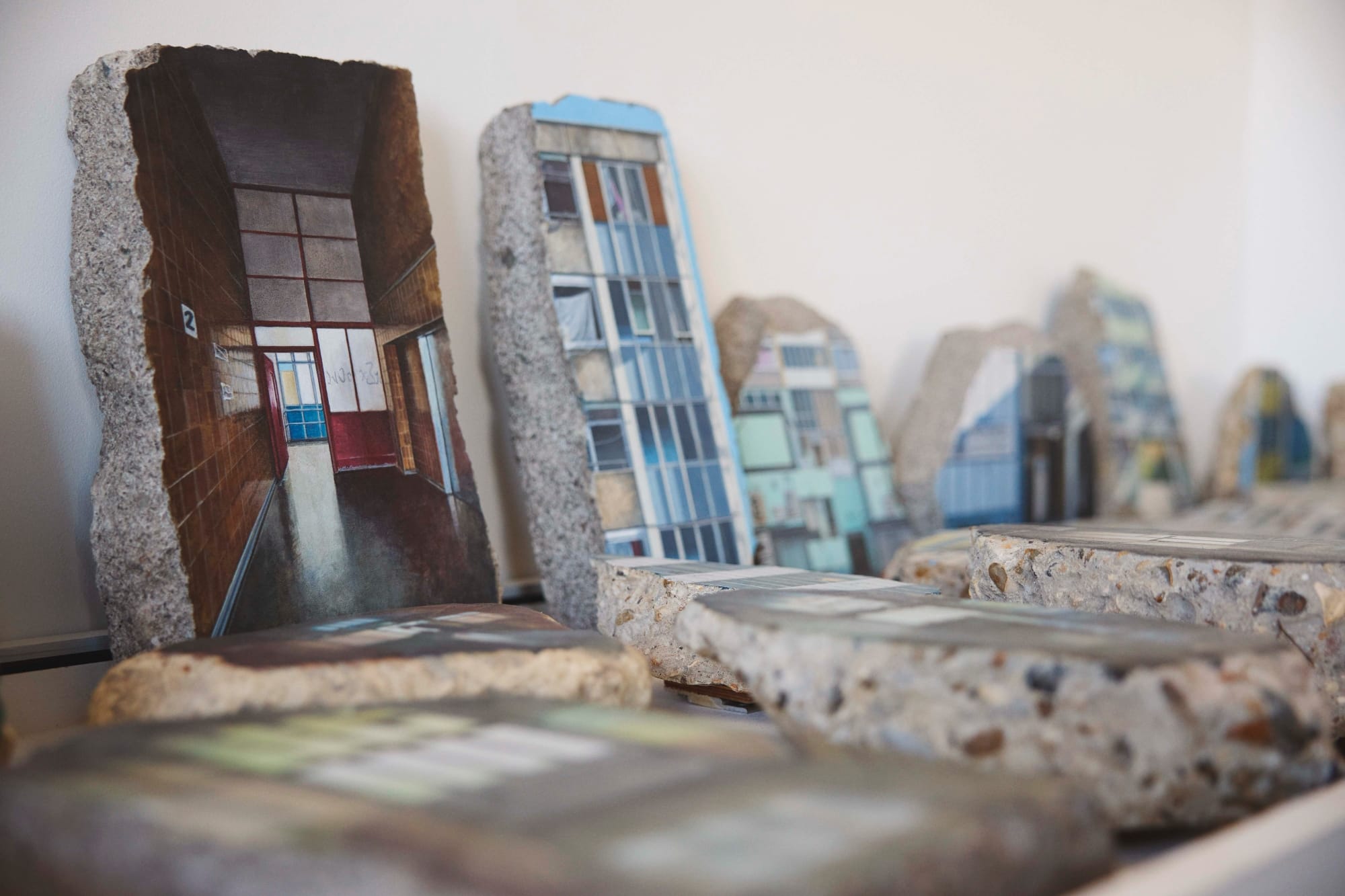 a collection of a concrete fragments with paintings of housing structures