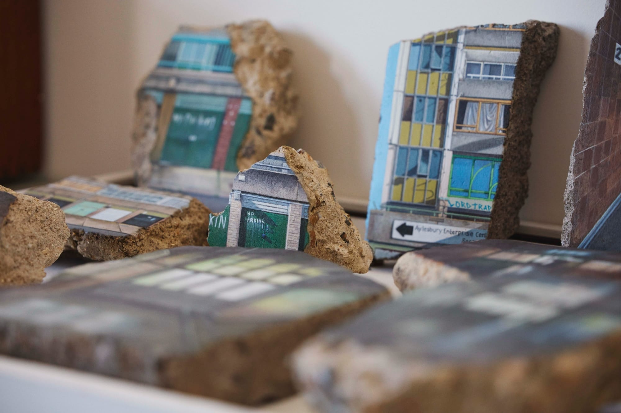 a collection of a concrete fragments with paintings of housing structures