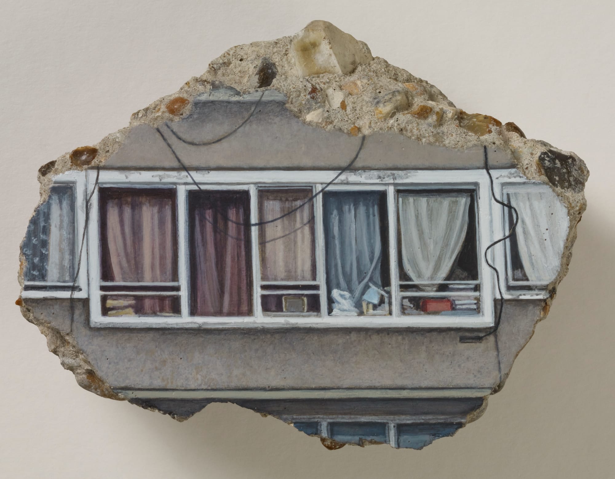a concrete fragment with a painting of windows and curtains