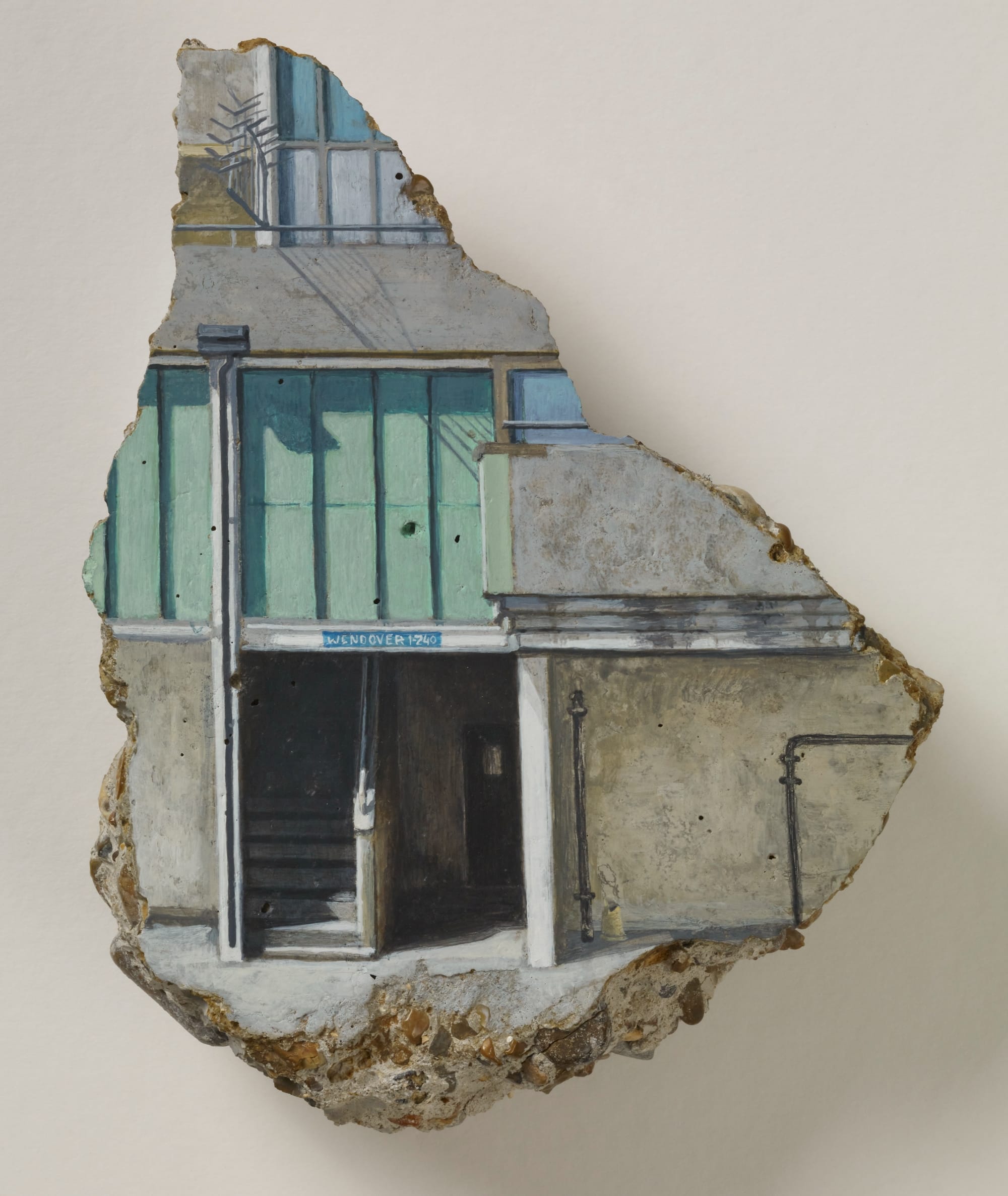a concrete fragment with a painting of a building with an open entrance