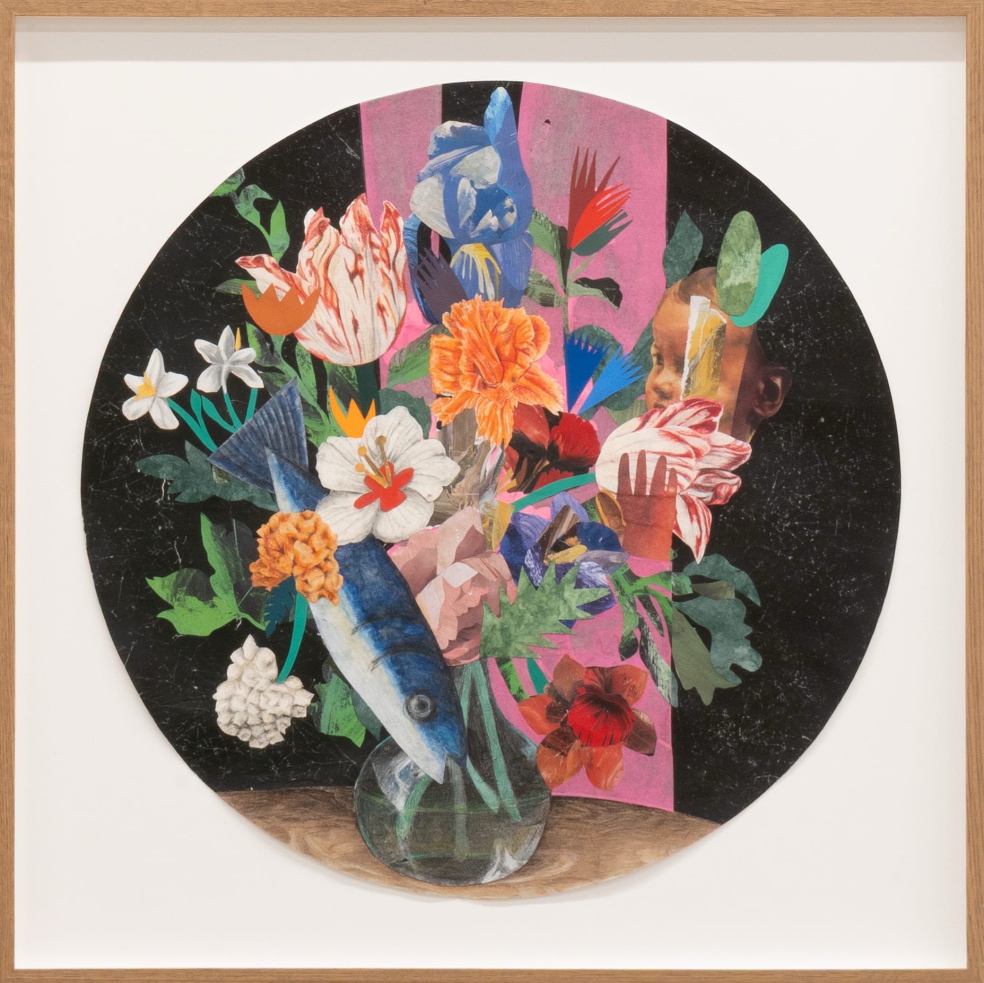 a framed circular collage of a still life bouquet with a fish and face