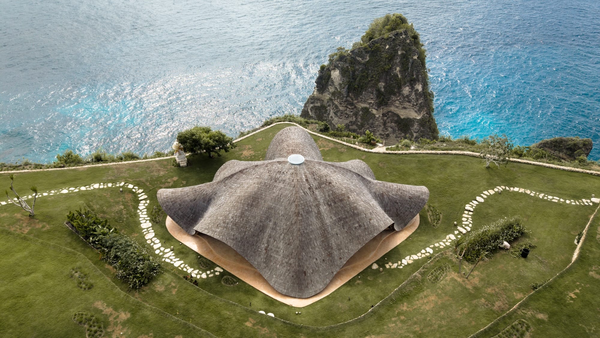 an aerial view of the roof of a yoga pavilion that is organic in form and resembles the rolling motion of a manta ray
