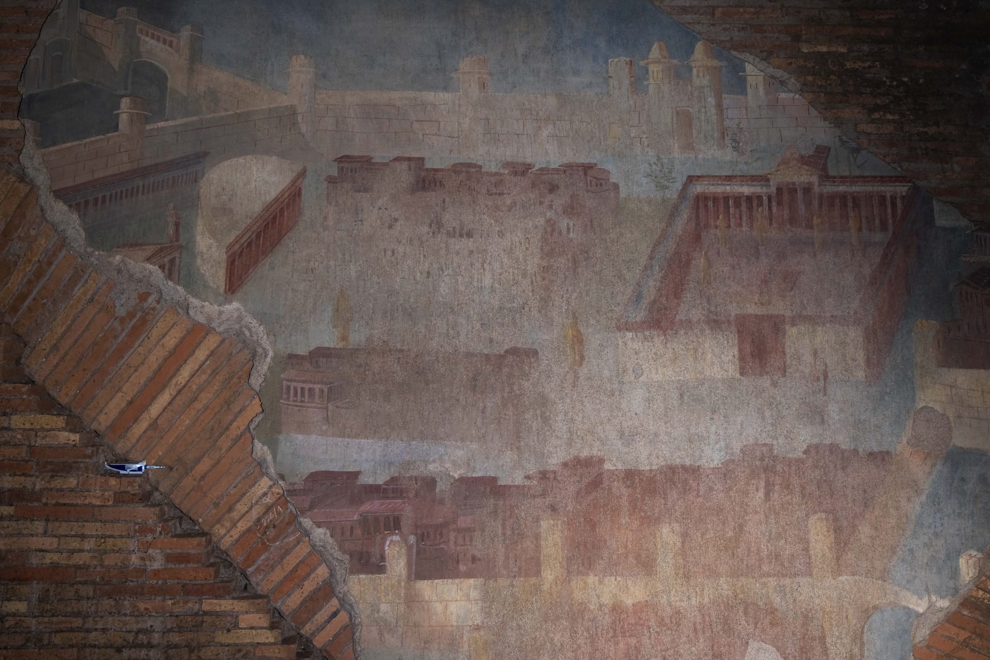 an ancient Roman fresco featuring buildings