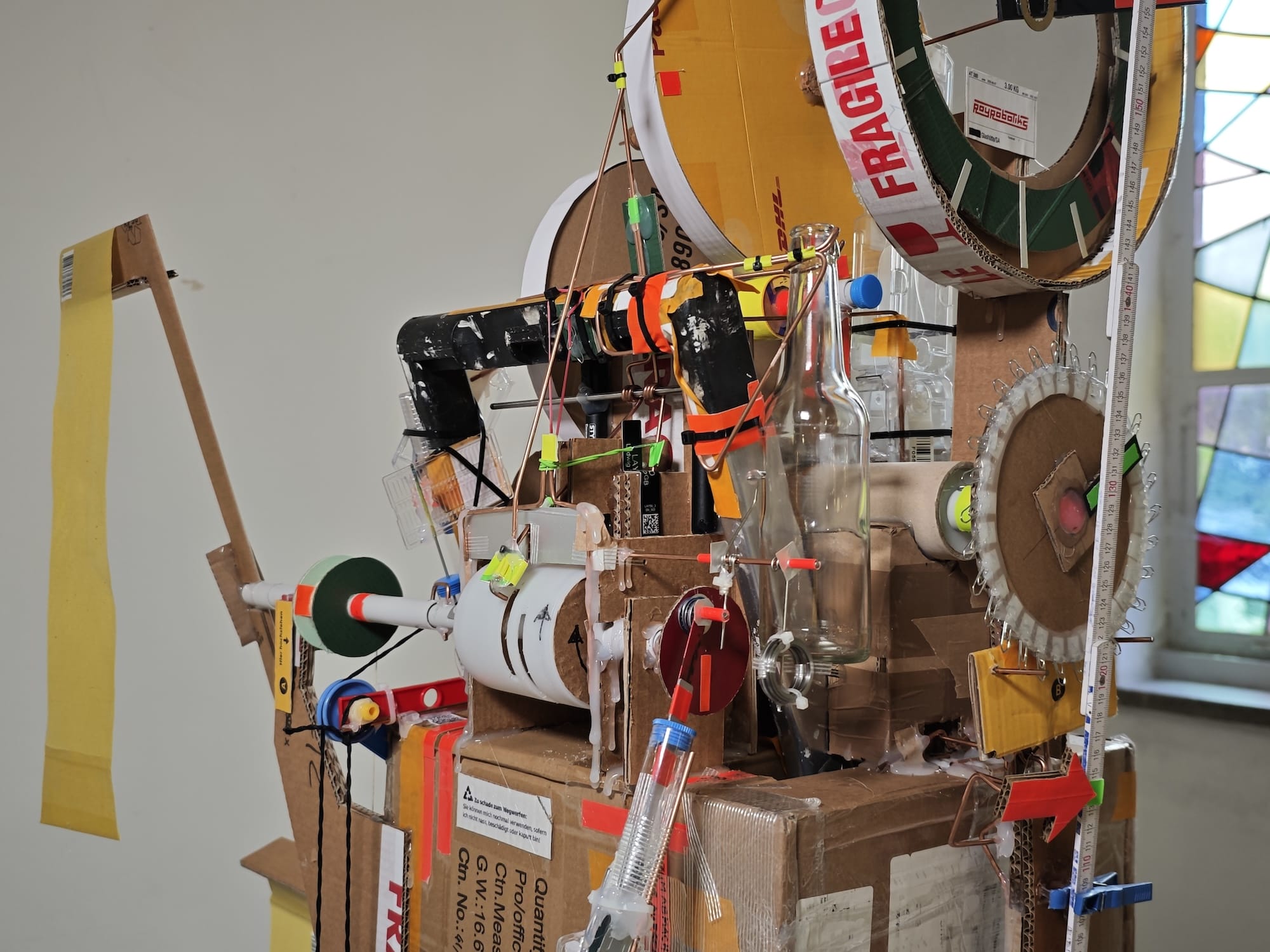 a detailed view of a sculptural, functional clock made from foraged trash