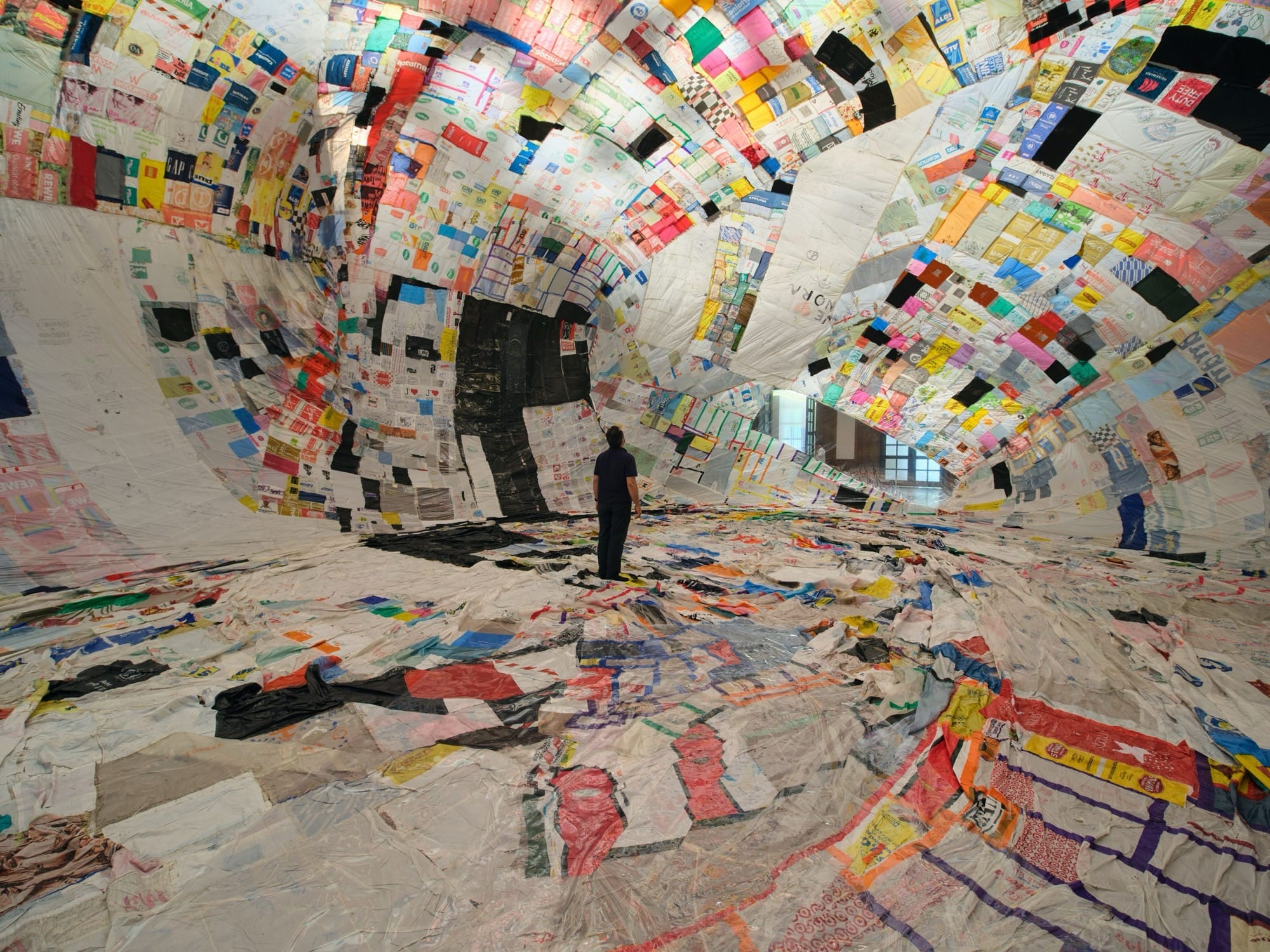 a person stands inside an immersive patchwork piece filled with air