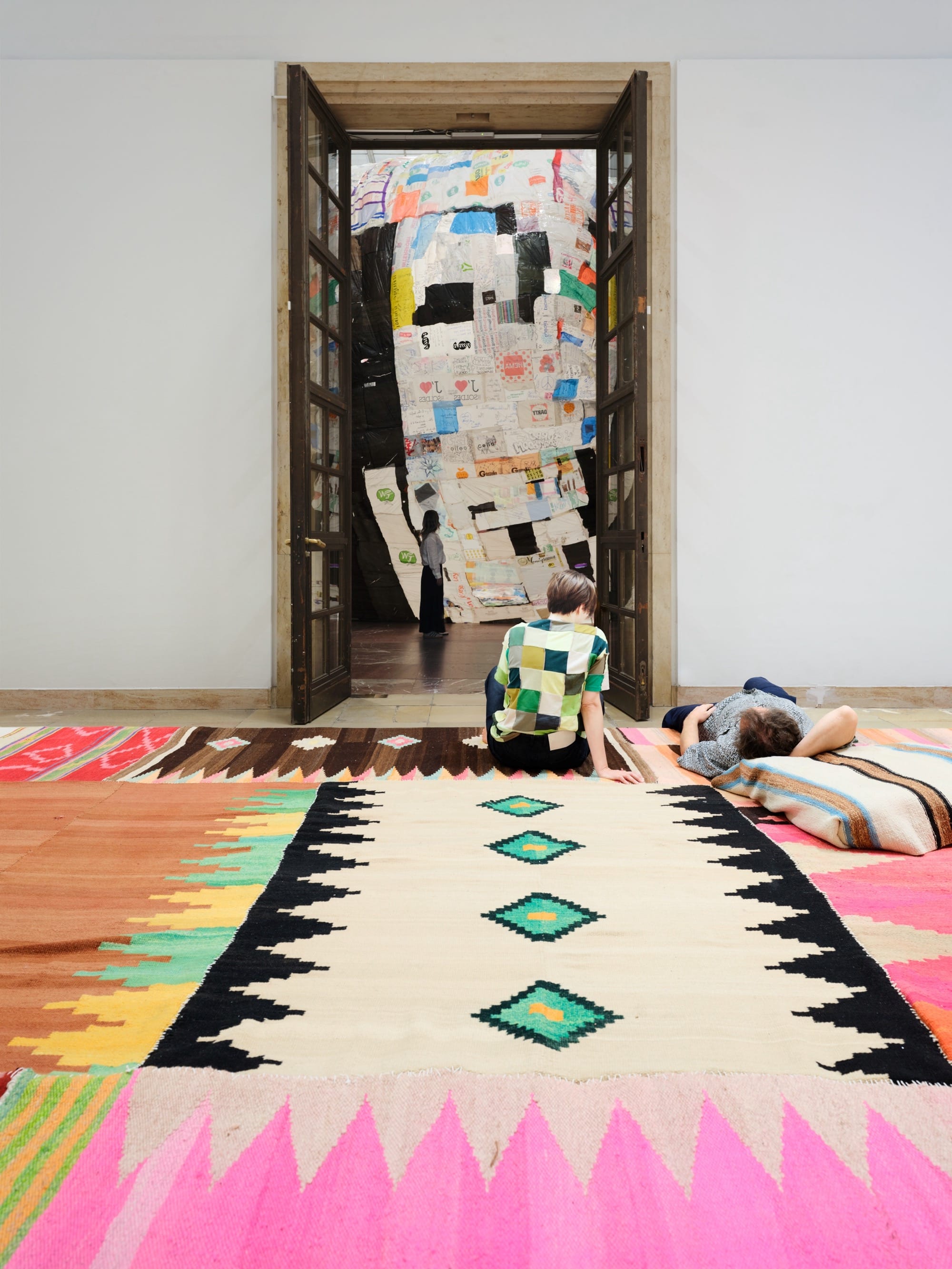 people rest on a vibrant tribal carpet