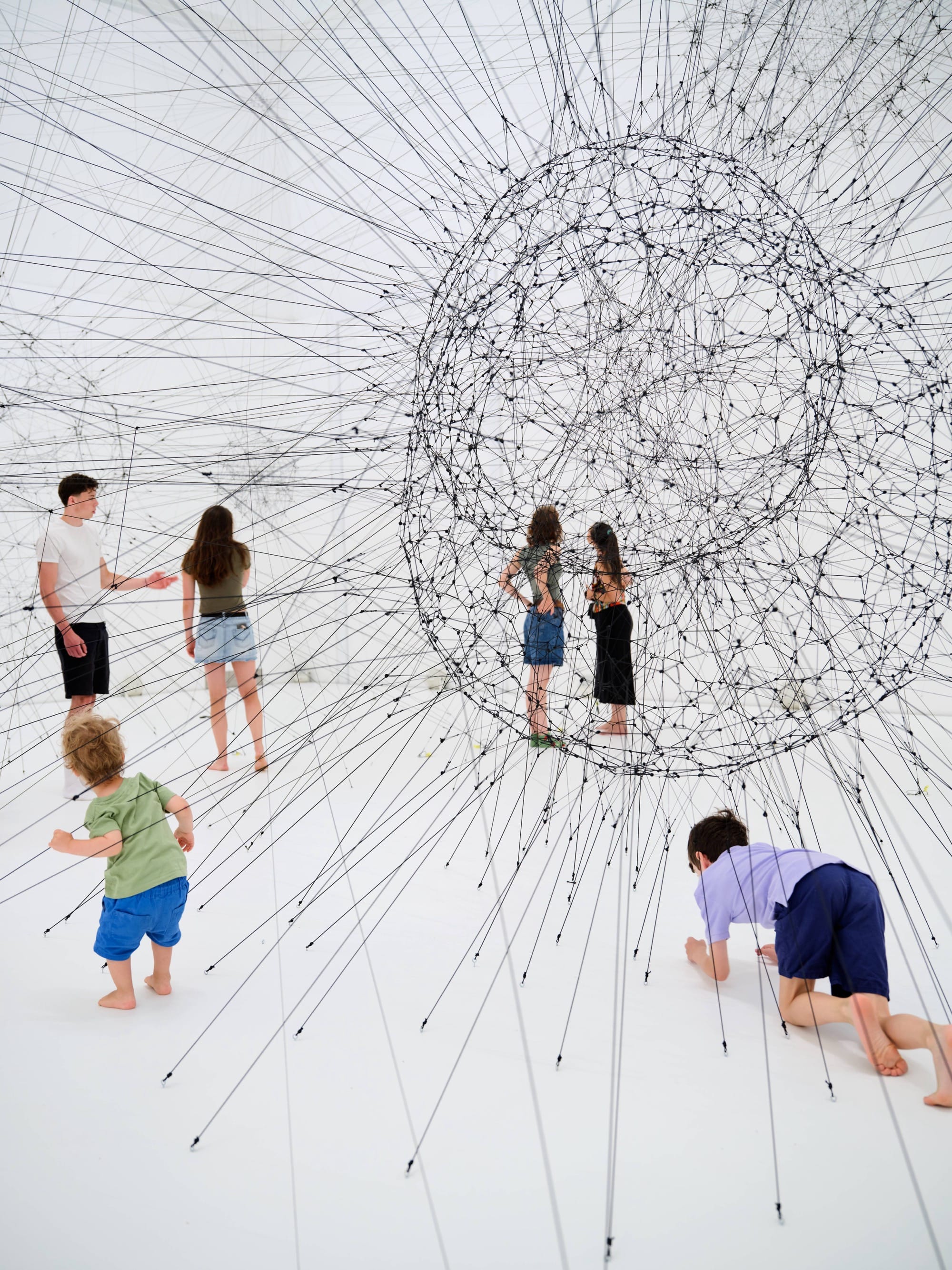 people in an installation of lines and circles