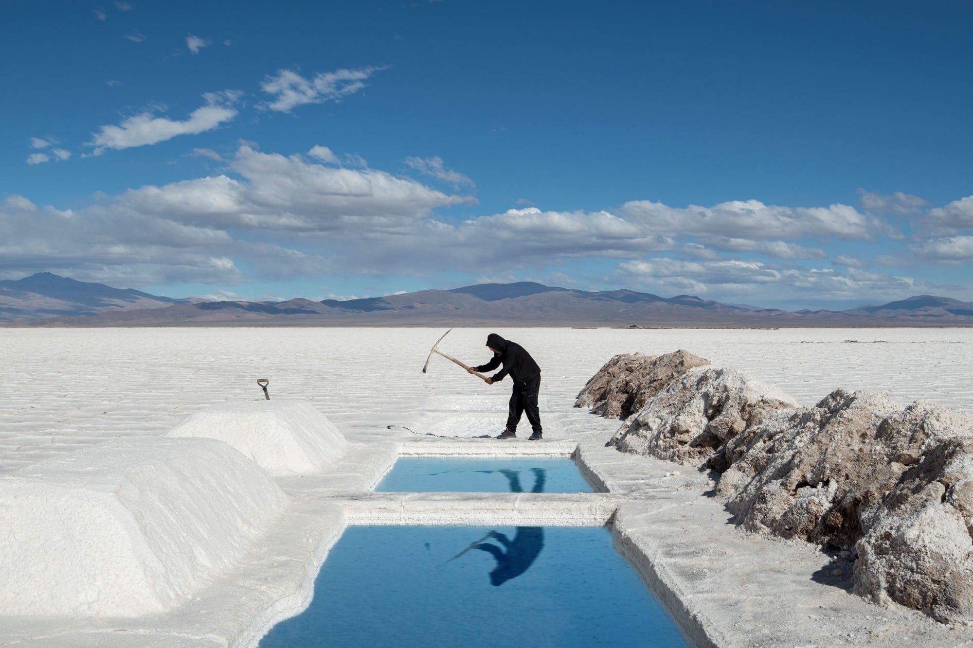 a person uses a pick axe on a snowy landscape