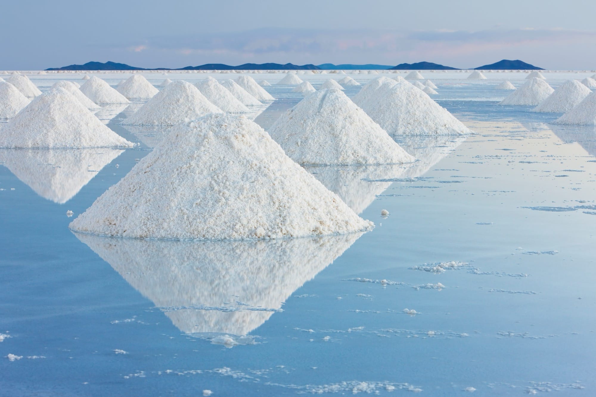 a large installation of snow mounds in a mirrored landscape