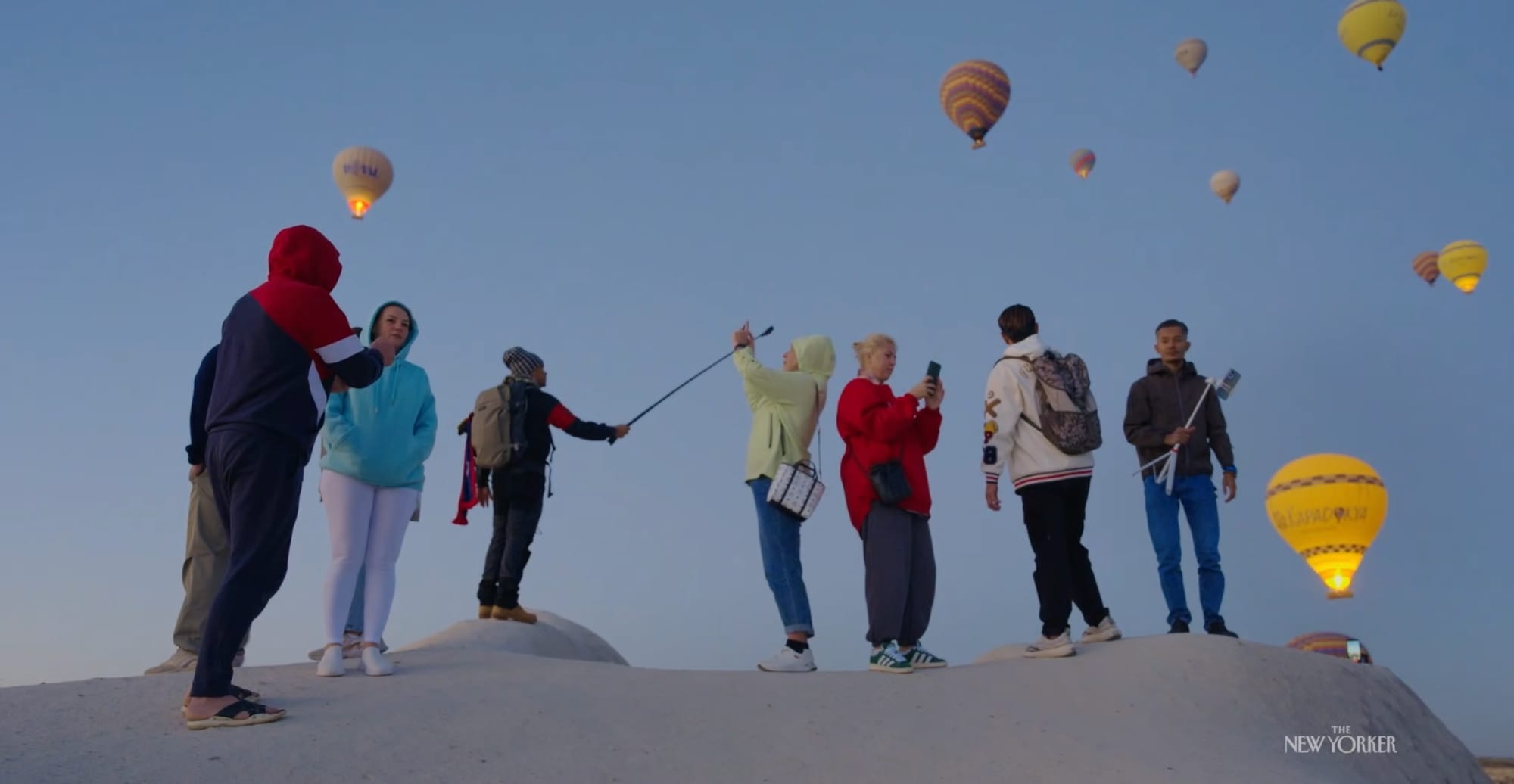 a still of people with cameras under hot air balloons