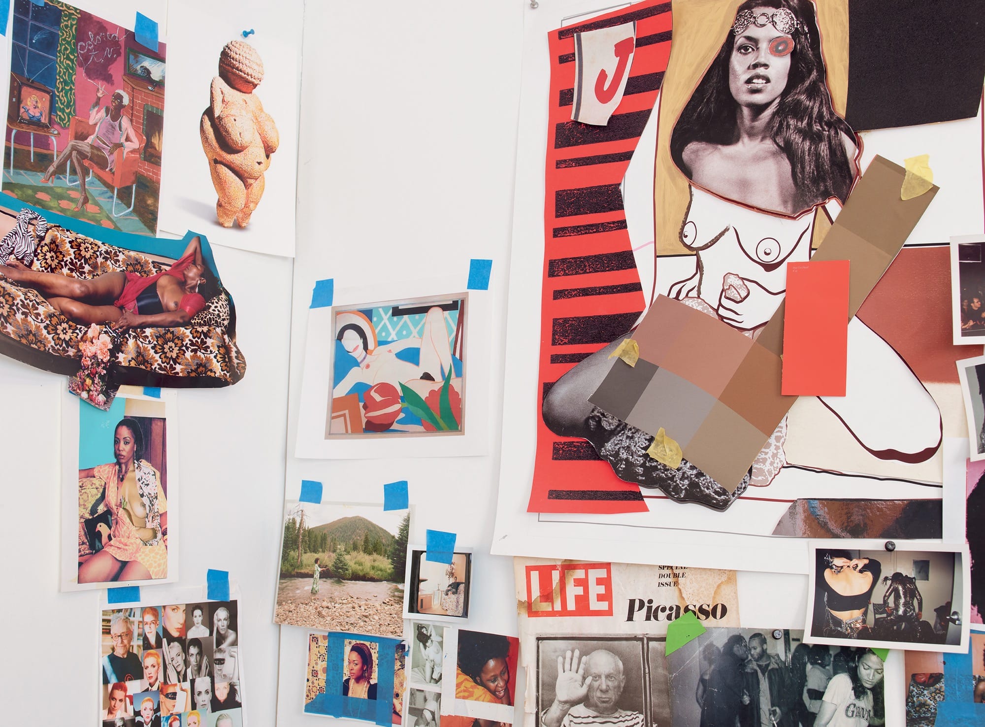 images taped to a studio wall