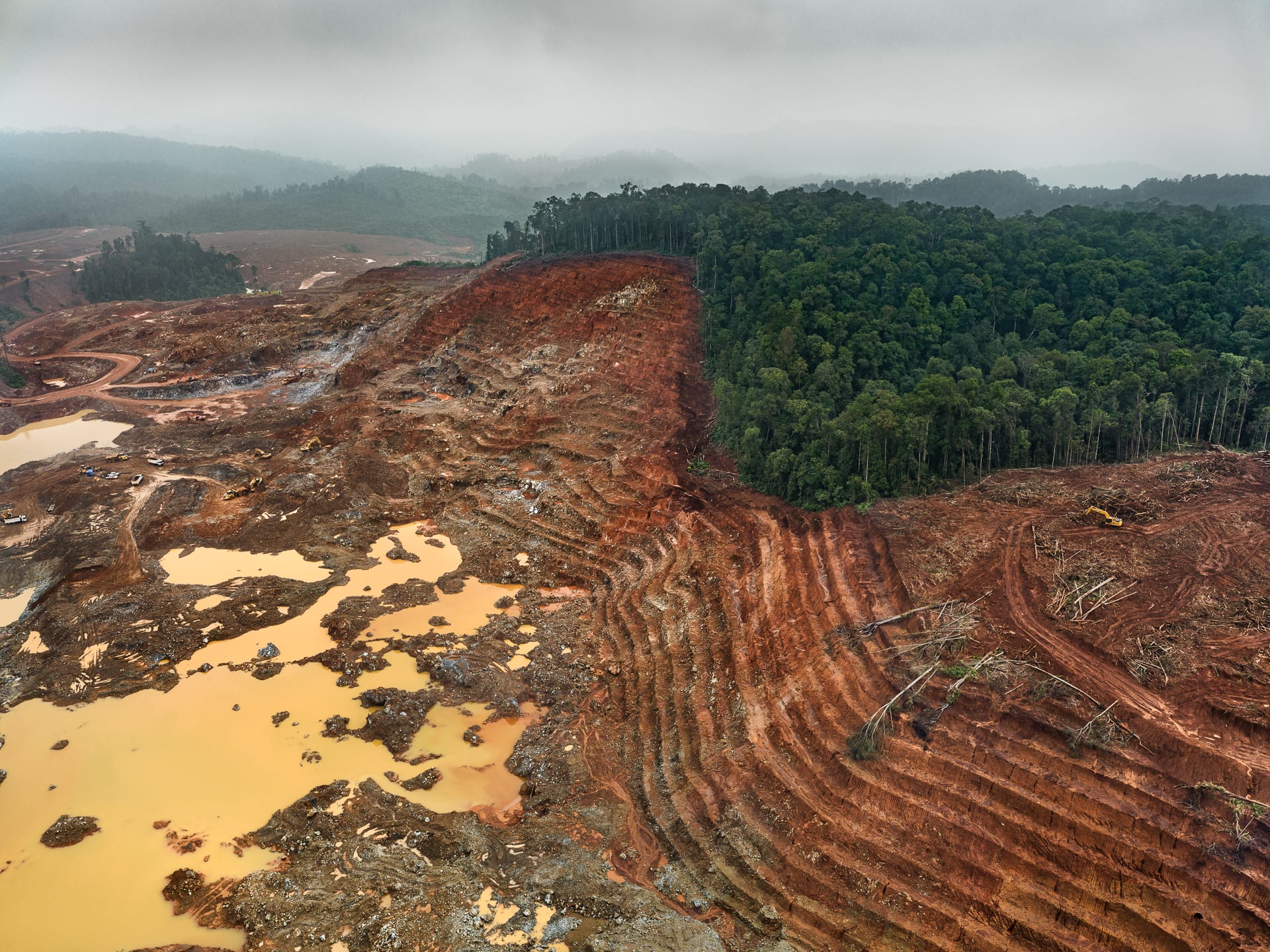 an aerial photo by tom hegen of a vast mining landscape