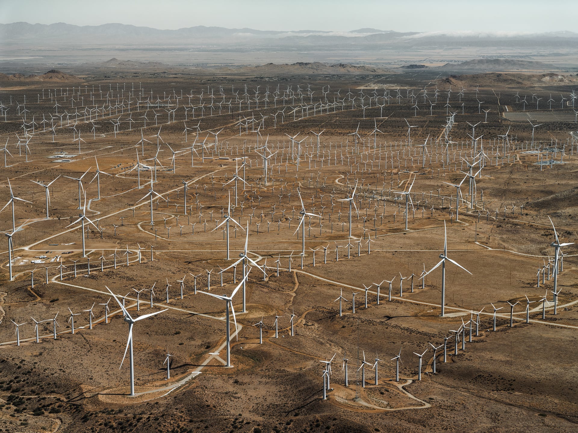 an aerial photo by tom hegen of a wind turbines