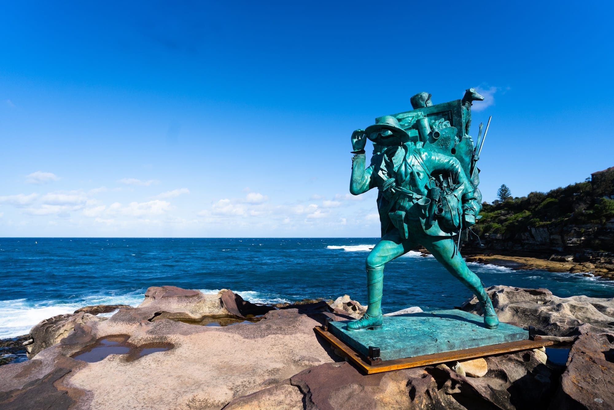 a sculpture of a man with binoculars and a large rucksack at Bondi Beach, NSW, Australia