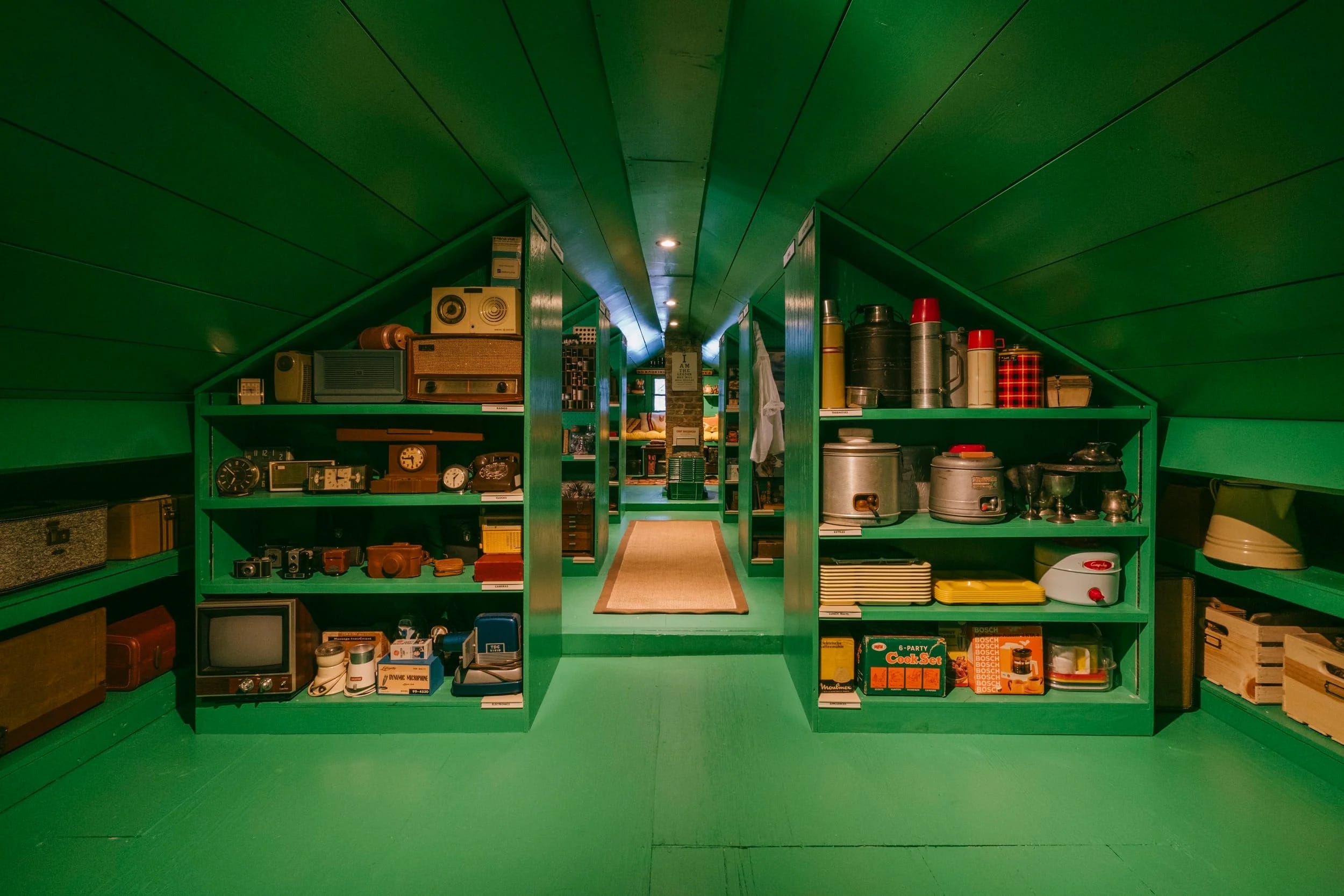 an attic painted bright green and lined with antiques
