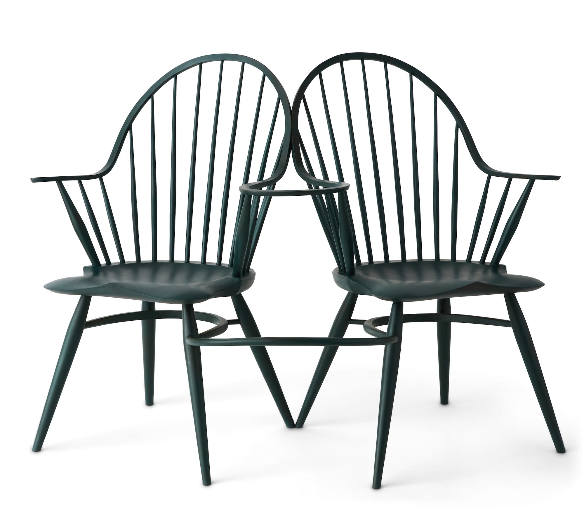 a pair of interlocked wooden spindle-backed chairs
