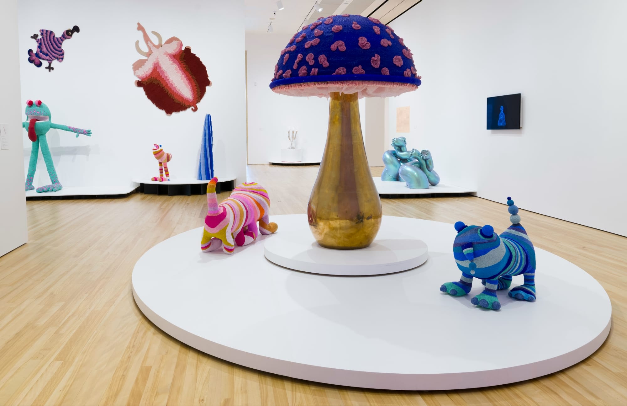 fantastical creatures and a large gold and purple mushroom by the haas brothers