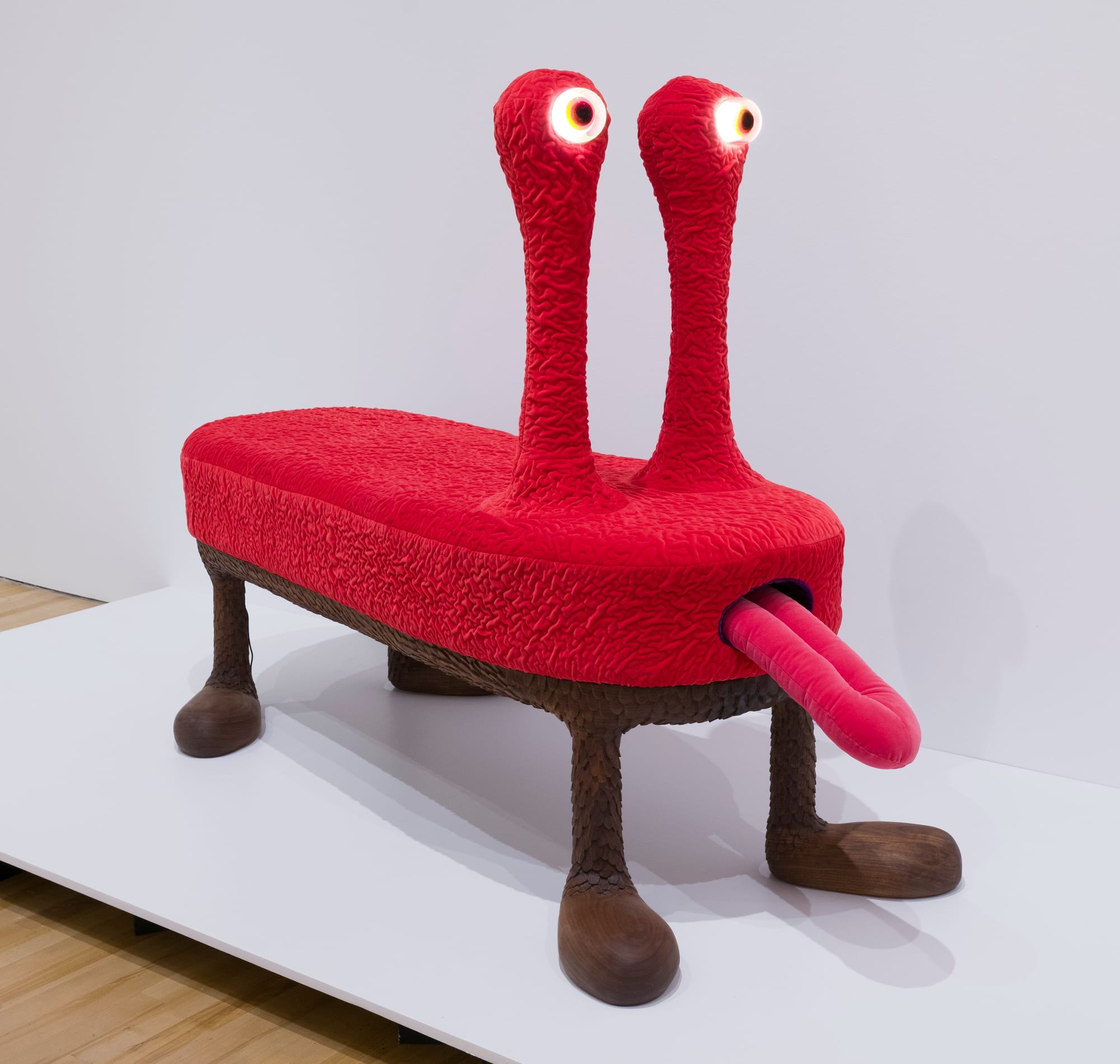 a red alien like stool with a big tongue sticking out