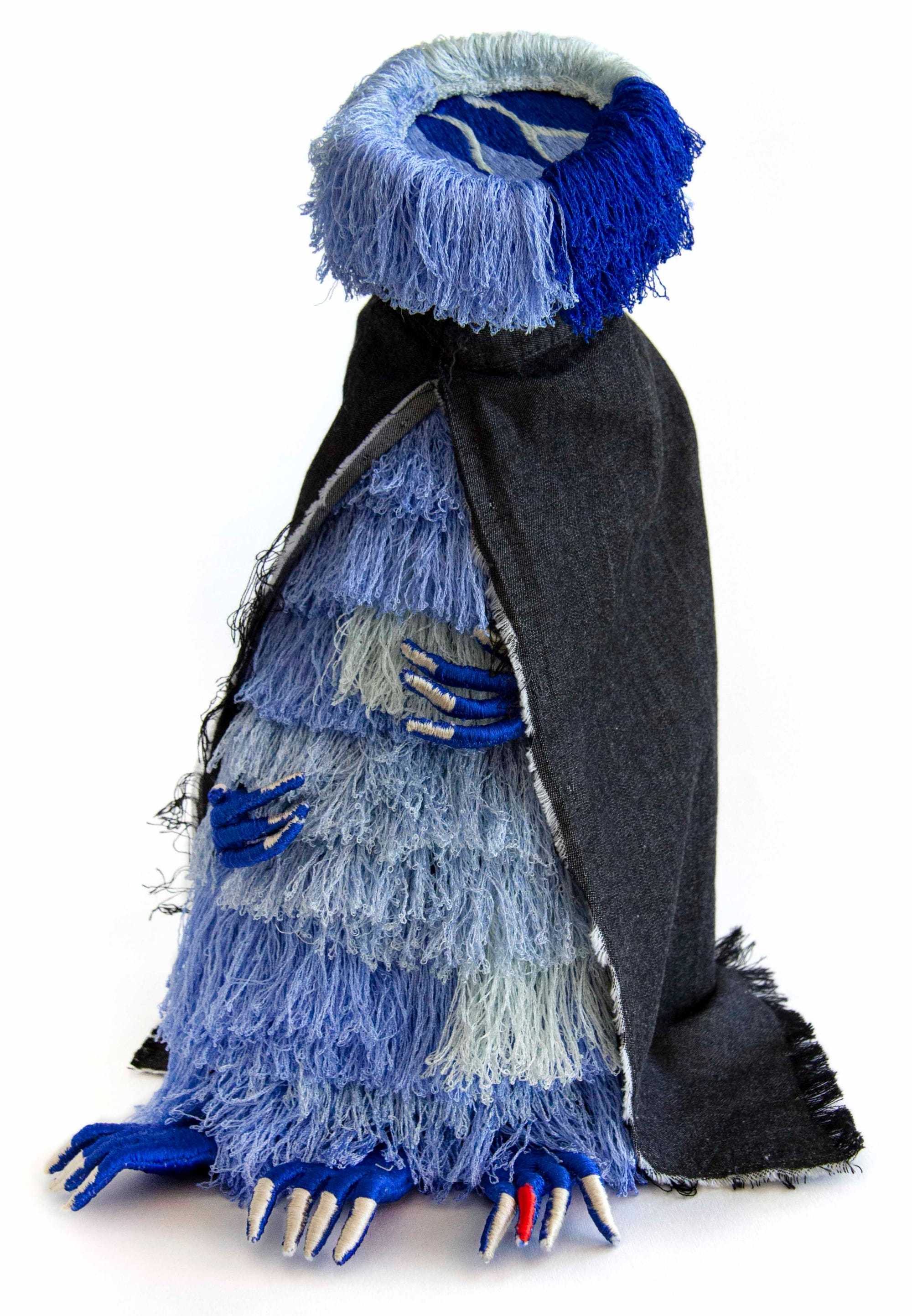 a creature-like sculpture made of various colored textiles