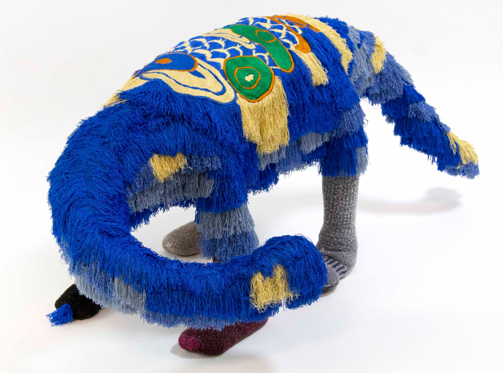 a creature-like sculpture made of various colored textiles