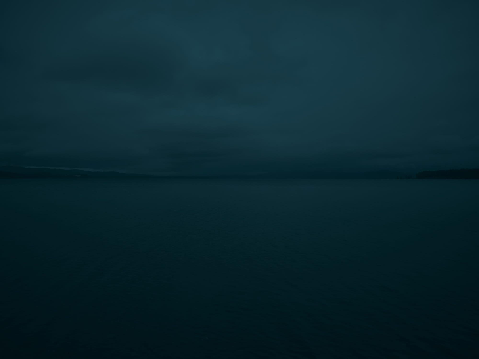 a dark, moody image of an open body of water