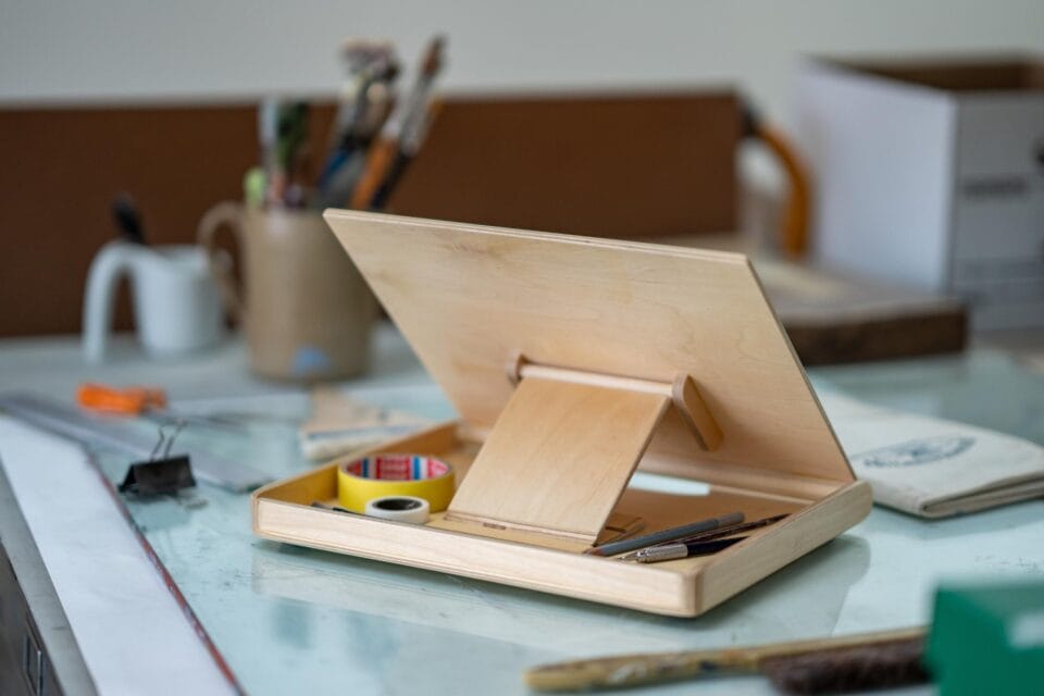 a wooden lap easel made by Bill Groot sits on a desk
