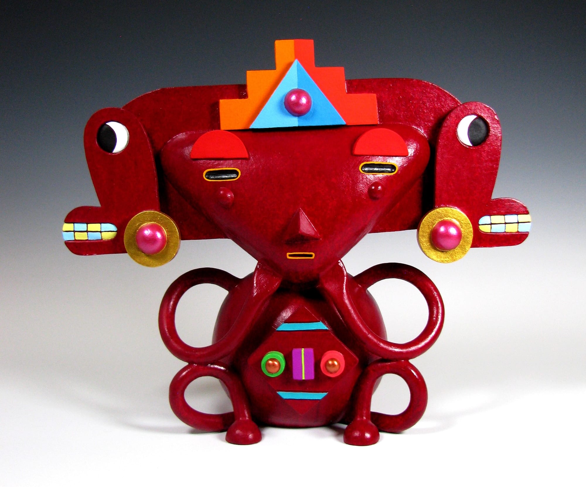 a colorful, abstract, ceramic sculpture of a cartoonish figure by Max Lehman inspired by ancient Mayan carvings