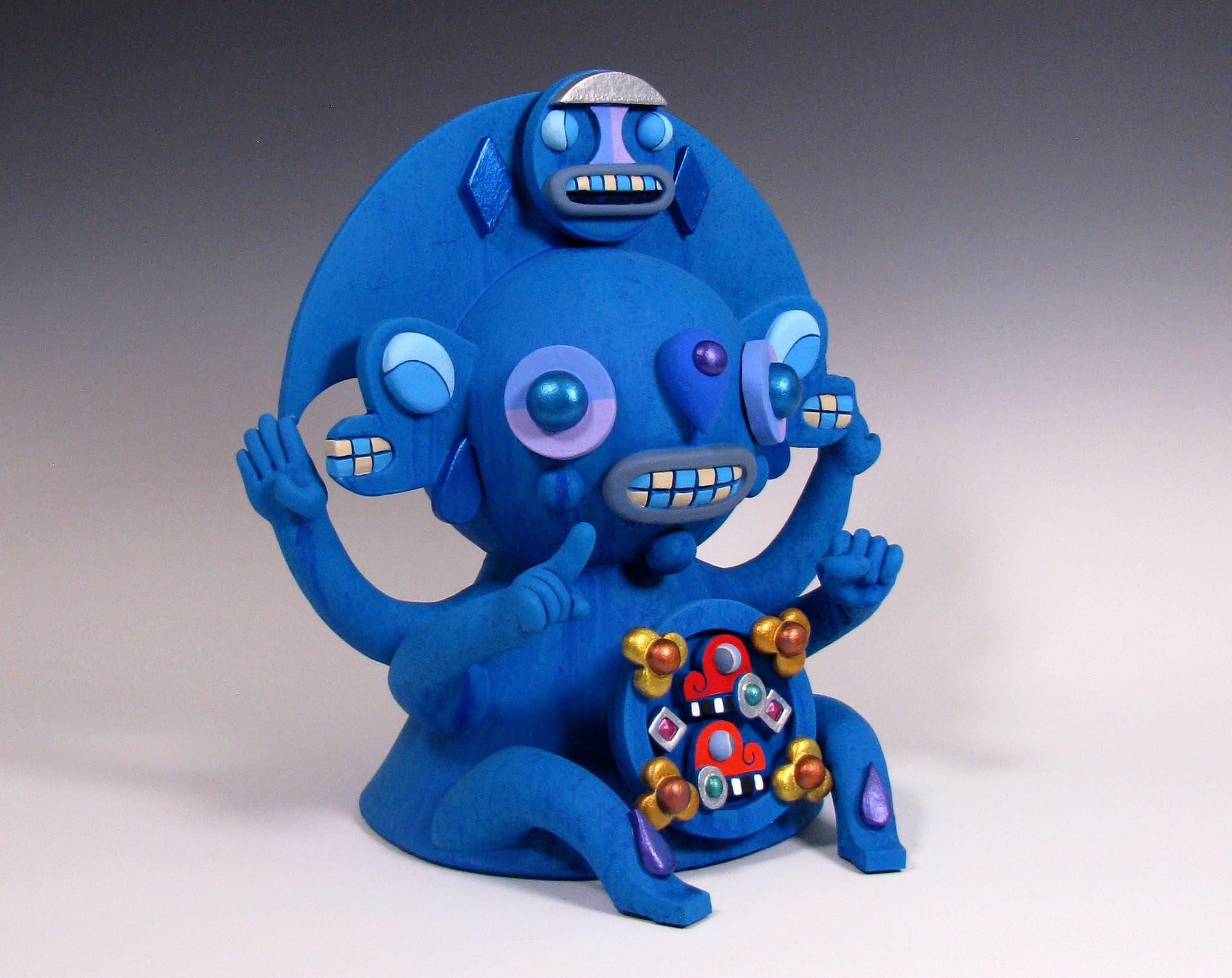 a colorful, abstract, ceramic sculpture of a cartoonish figure by Max Lehman inspired by ancient Mayan carvings