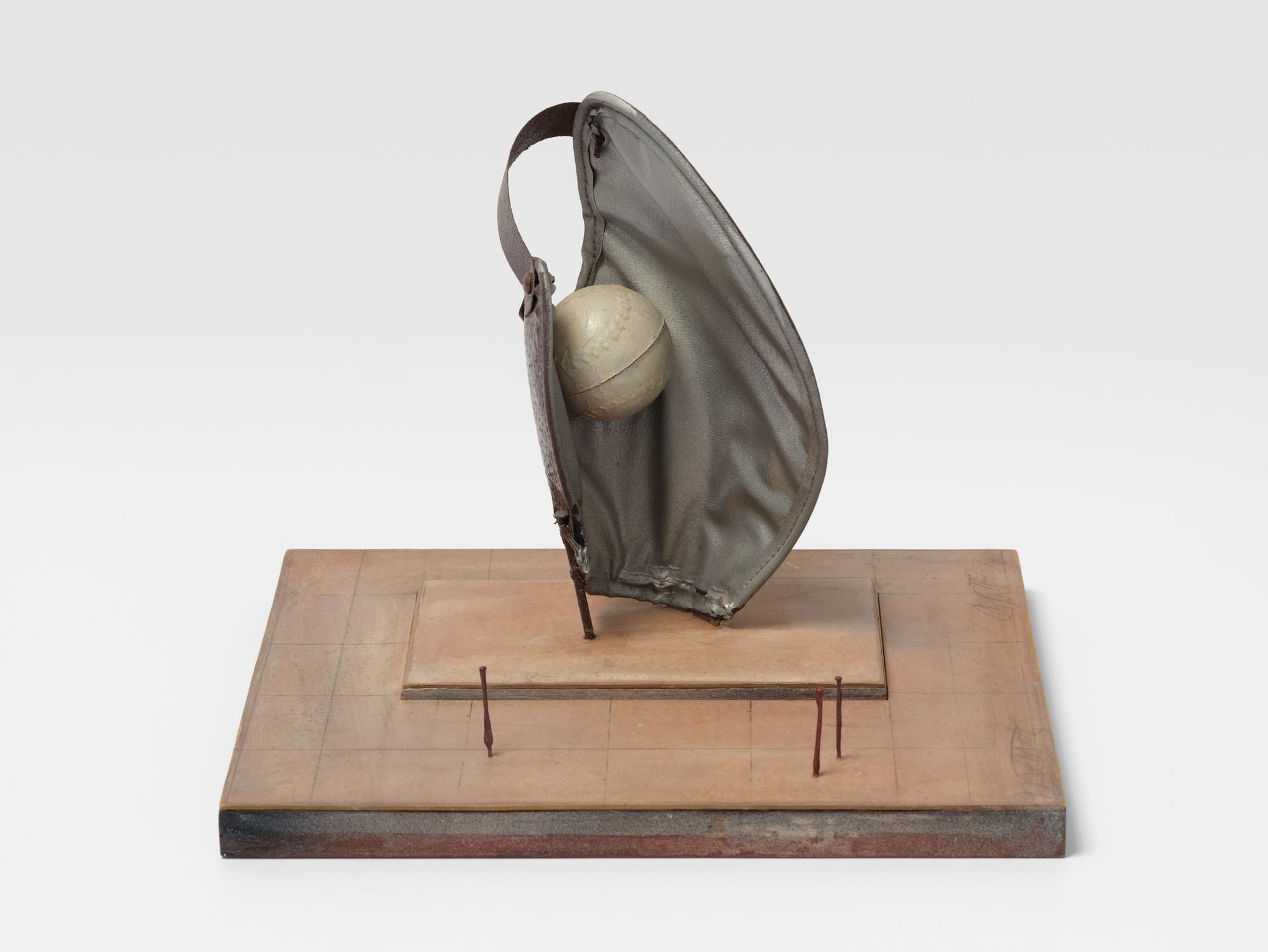 a sculpture of a ball in a mitt by Claes Oldenburg