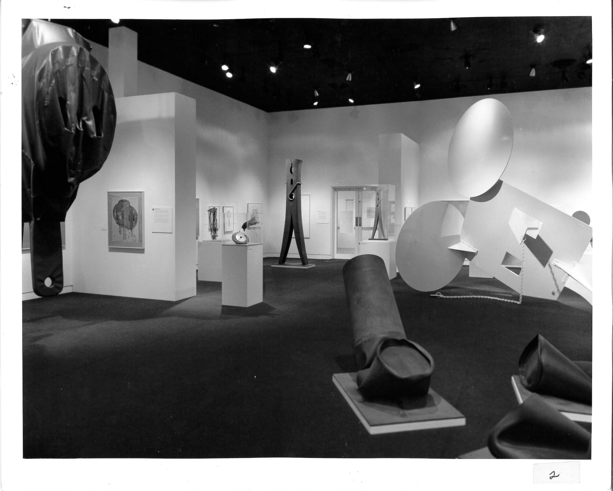 a historical black-and-white image of an exhibition of Claes Oldenburg's sculptures at MIT