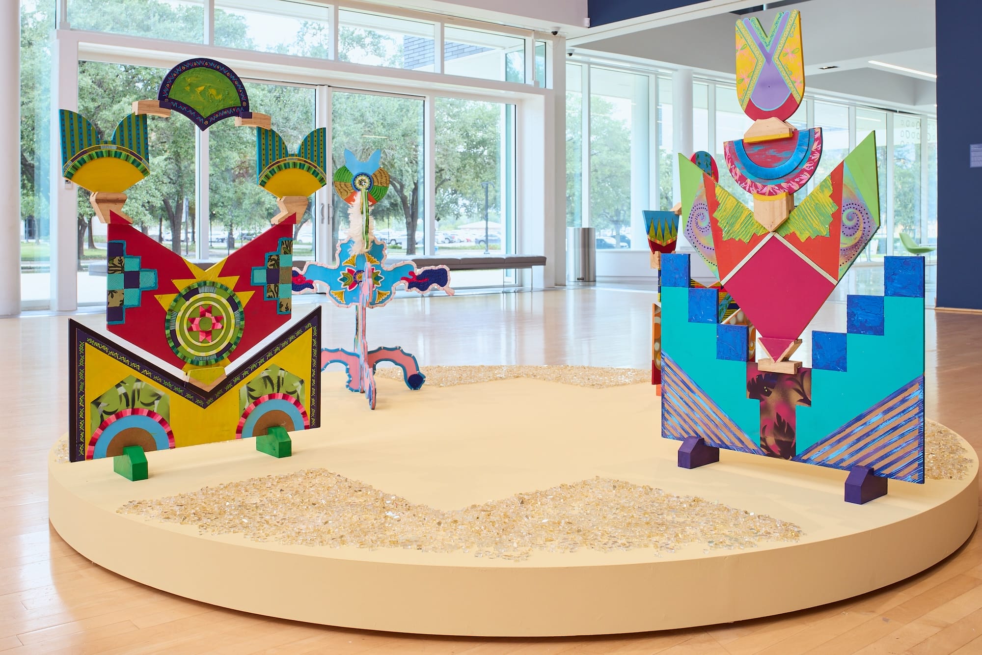 A series of colorful, geometric sculptures in a gallery space