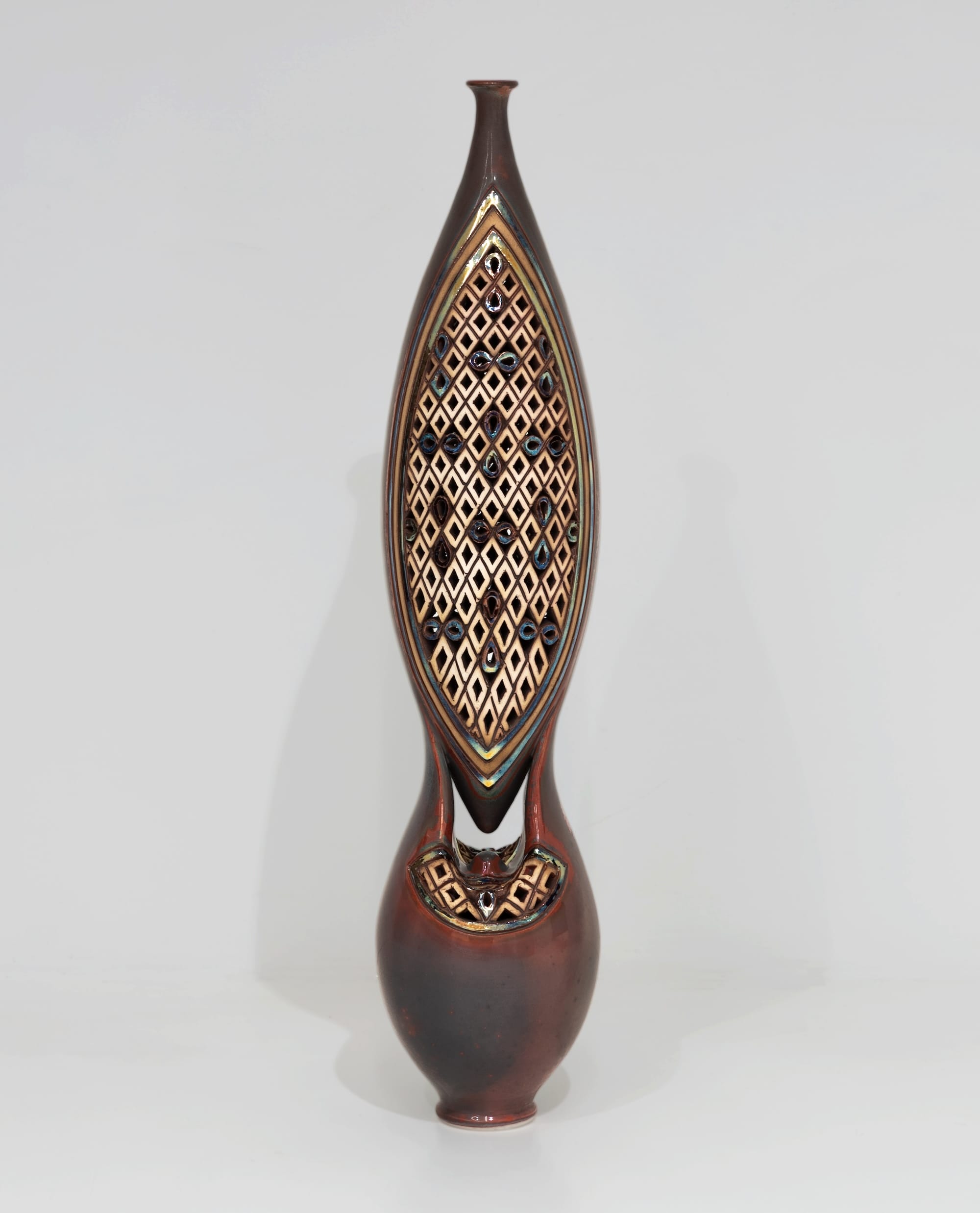 an ornate ceramic sculpture with connected upper and lower vessels