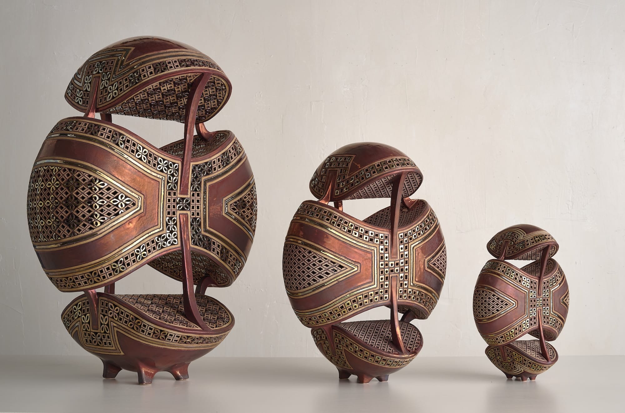 a series of three ornate ceramic sculptures