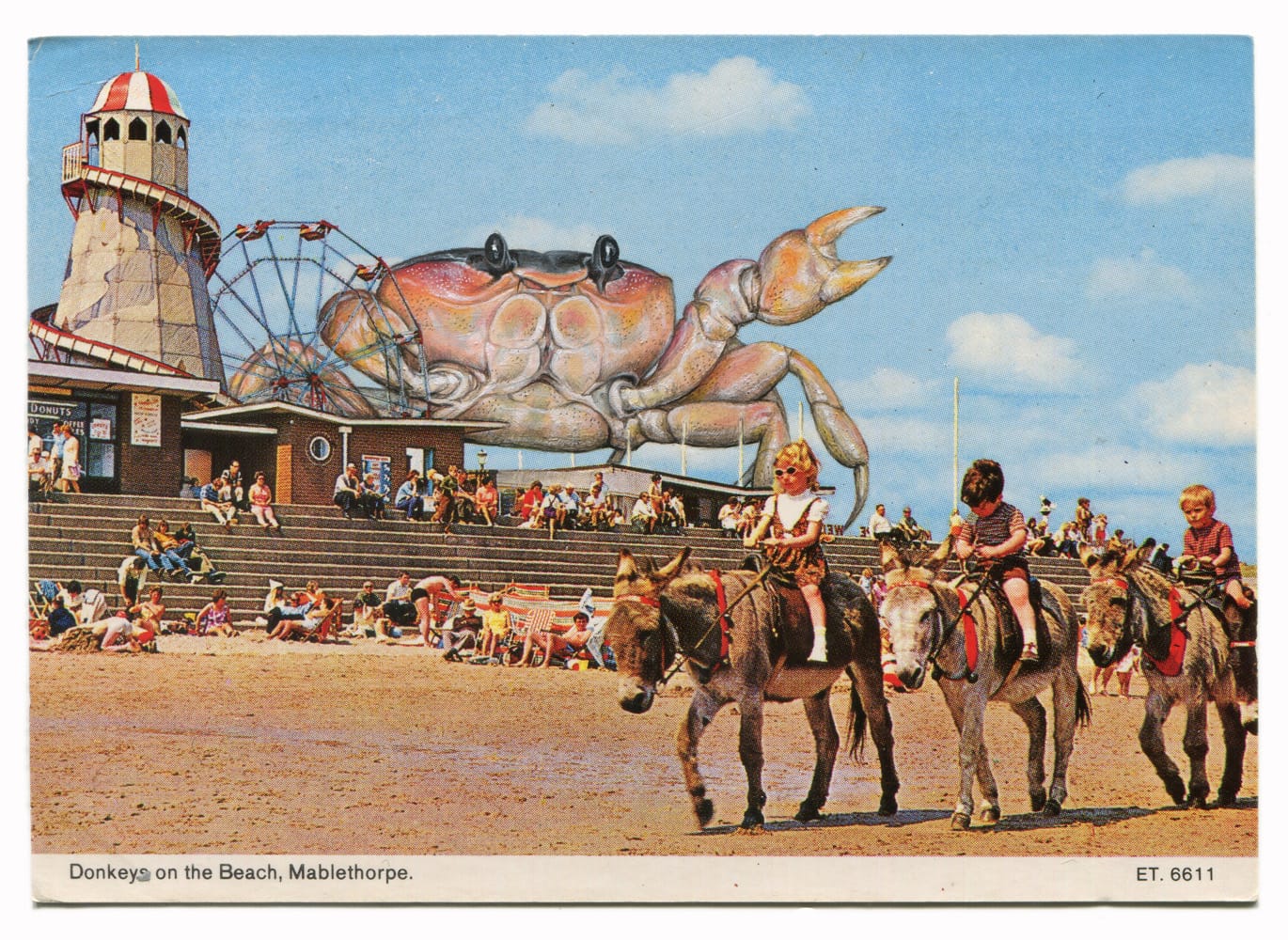 a painting by Rose Sanderson on a vintage postcard of an enormous crab looming over donkeys on the beach