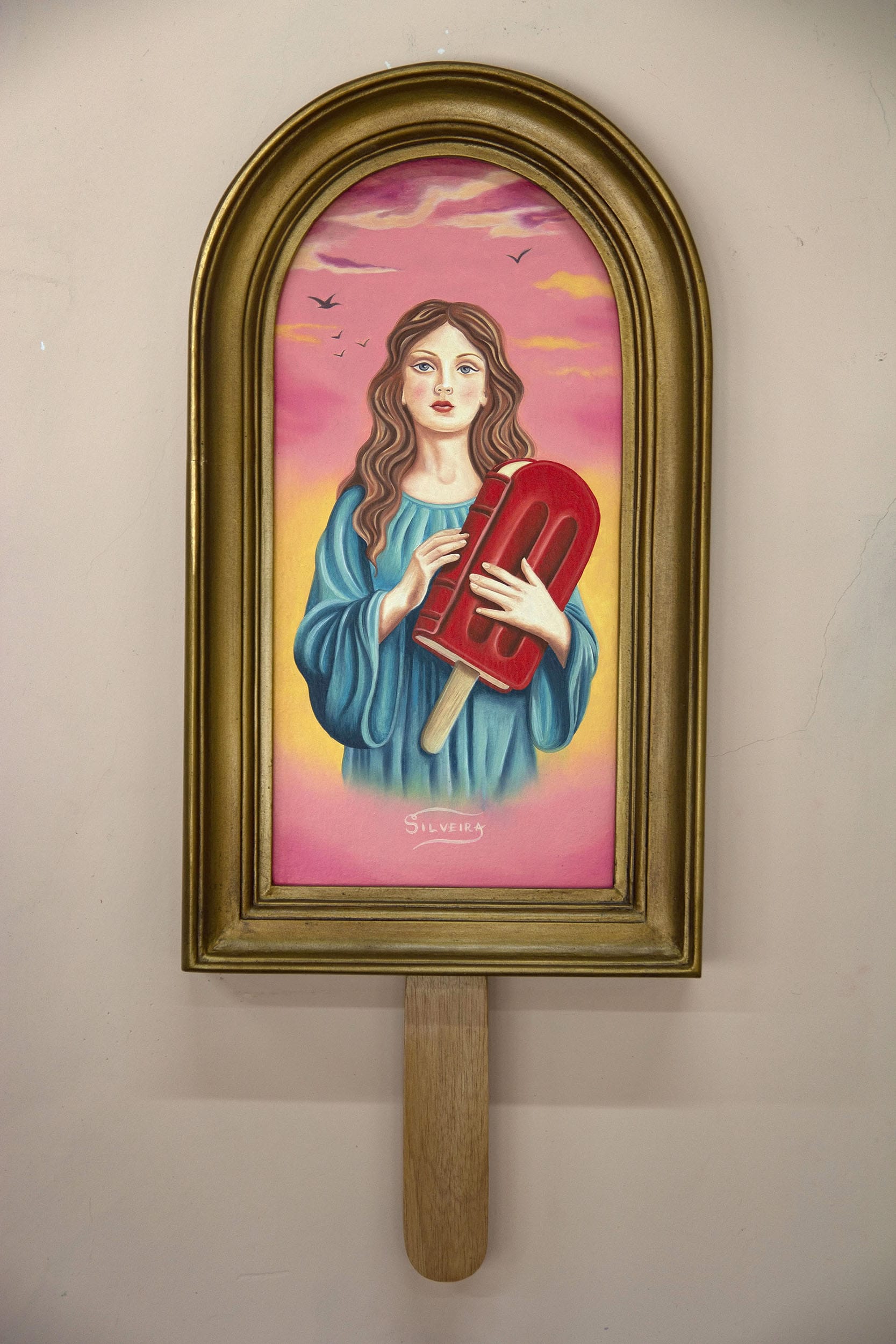 a vertical painting in a hand-carved wooden frame shaped like a popsicle with an image of a woman in the center holding a giant popsicle, inspired by religious paintings